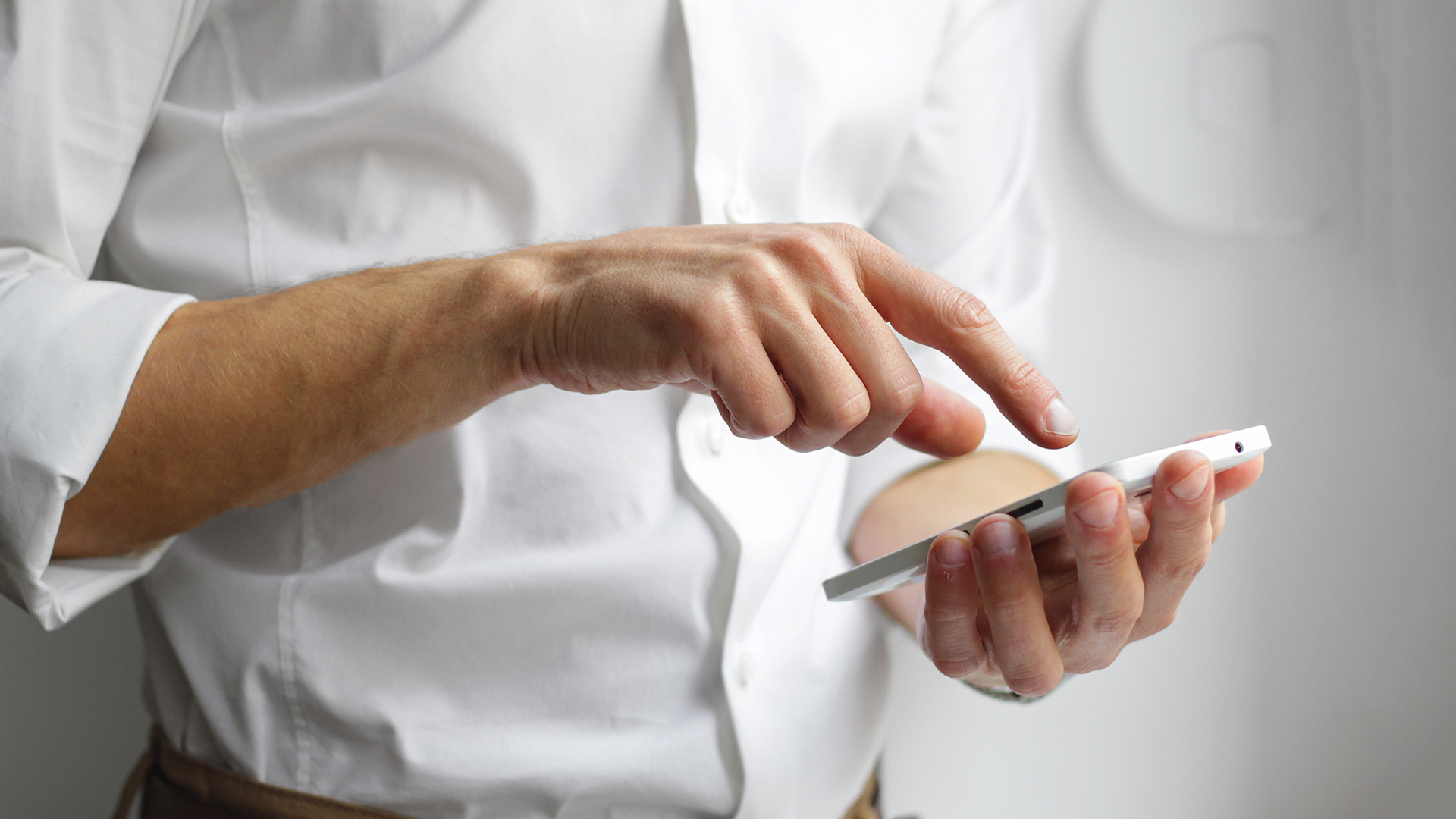 Man typing on mobile phone