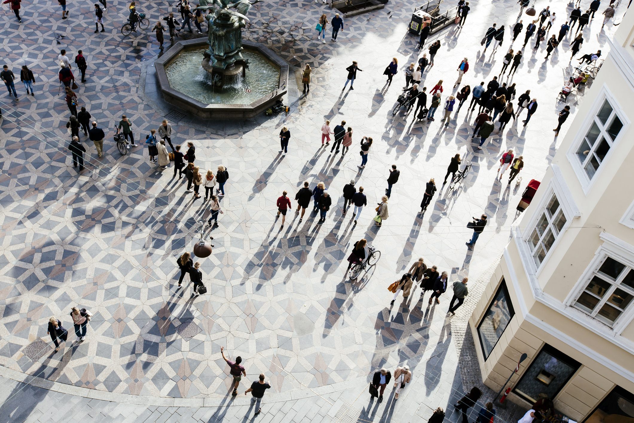 A public square in Copenhagen seen from above, with a bunch of people.